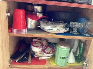 um armário cheio de pratos e outros utensílios de cozinha em Sticks creekside Living em Turtletown