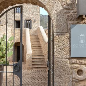 an entrance to a stone building with a staircase at Korona Boutique Hotel in Oitylo