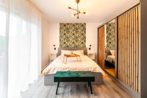 a bedroom with a bed with a table and a window at Jackal Holiday House with a heated pool and a jacuzzi in Lovreć +90 photos