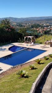 a swimming pool with a view of a city at Casa Escarpas do Lago, Capitólio-MG in Capitólio