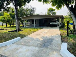 a house with a car parked in the driveway at CocoHouse in Horconcitos