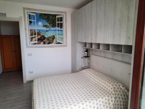 a bedroom with a bed and a window at Appartamenti Miramare in Marina di Camerota
