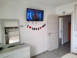 a bedroom with a tv on a wall at Appartamenti Miramare in Marina di Camerota