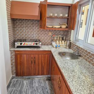 a kitchen counter with a sink and a window at Roof Top Resort in Murree +91 photos