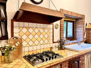 a kitchen with a stove and a sink at Holiday home, Francavilla di Sicilia in Francavilla di Sicilia