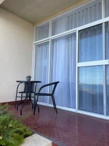 a patio with a table and chairs in front of a window at Makai ‘Toward the Sea’ in Port Lincoln