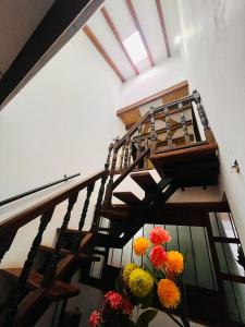 a spiral staircase with flowers in a room at Hostal El Palacio Del Descanso in Villa de Leyva