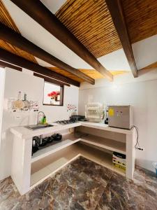 a kitchen with a counter and a sink in a room at Hostal El Palacio Del Descanso in Villa de Leyva