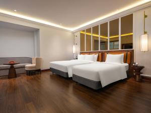 Voodi või voodid majutusasutuse Minerva Premium Hotel toas