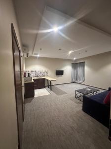 a living room with a couch and a table at شقق الريم الجديد للشقق المخدومة Al Reem Al Jadid residence in Yanbu +54 photos