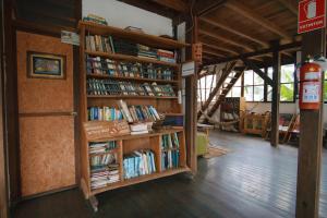 a room with two book shelves filled with books at La Fauna Hotel in Puerto Maldonado