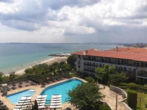 a view of a resort with a swimming pool and a beach at MONASTERY Seafront Apartments in Sveti Vlas