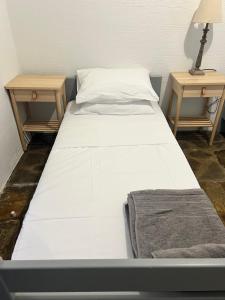 a bed in a room with two end tables at Villa Aliki Piskopiano in Hersonissos +26 photos