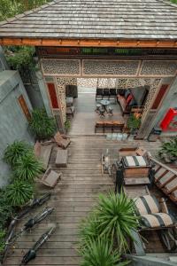 an overhead view of a wooden deck with a house at House Of Passion Amphawa in Amphawa