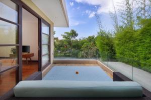 an open living room with a view of a golf ball at Beautiful Bali Villas in Legian