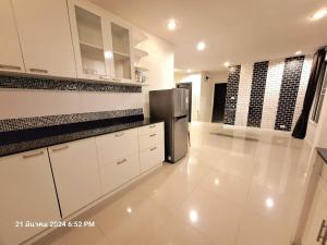 a kitchen with white cabinets and a stainless steel refrigerator at Plus 1 2 3 Hua-Hin Private Poolvilla from beach 3km in Hua Hin