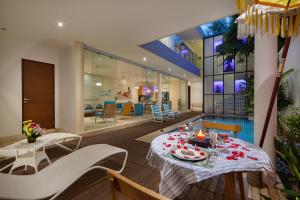 a dining room with a table and chairs at Beautiful Bali Villas in Legian