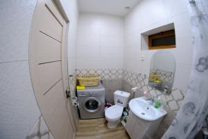 a bathroom with a washing machine and a sink at Gam guest house 1 in Meghri