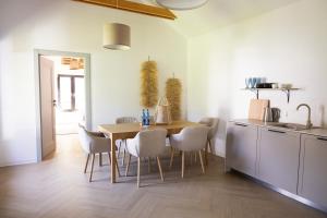 a kitchen with a table and chairs in a room at Zakątek nad Wkrą in Goławice