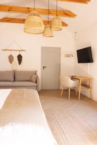 a bedroom with a bed and a table and a couch at Zakątek nad Wkrą in Goławice