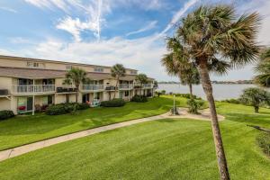 anterior view of a building with a palm tree at Sand Dollar E200 in Pensacola Beach