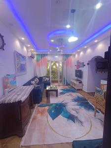 a large living room with a blue ceiling at Cozy apartment with a private garden in Giza in Sheikh Zayed