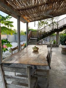 a wooden table with a bowl of fruit on it at Peponi Lodge in Jambiani