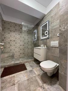 a bathroom with a toilet and a sink at Studio CAMIS in Năvodari +5 photos