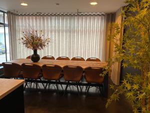 długi stół z krzesłami i wazon kwiatów w obiekcie La Petite Fleur w mieście Baarle-Nassau