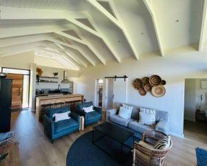 a living room with a blue couch and a fireplace at The Old Oke Riverhouse in Malgas