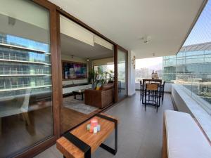 a living room with a couch and a table at Exclusive Apt Parque San Damin in Santiago