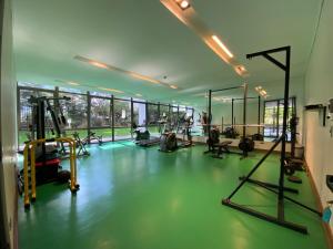 a gym with several people exercising in a gym at Exclusive Apt Parque San Damin in Santiago