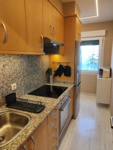 a kitchen with a sink and a counter top at Apartamento Pedra Pateira in Ribeira
