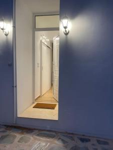 a mirror on the side of a room with a hallway at Myrtoan Sea View Apartment in Velanídhia
