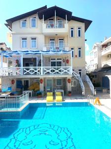 a hotel with a swimming pool in front of a building at Room in Apartment - Beautiful Holiday Home In Resort Centre in Side