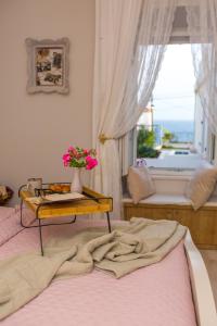 a bedroom with a bed with a table with flowers on it at Back in Time Luxury Dubrovnik 2 in Dubrovnik