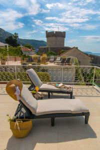 two lounge chairs sitting on top of a roof at Back in Time Luxury Dubrovnik 2 in Dubrovnik