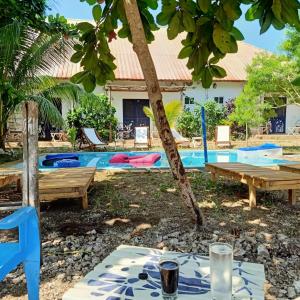 a picnic table in front of a swimming pool at Ocean Breeze Boutique Hotel in Nungwi