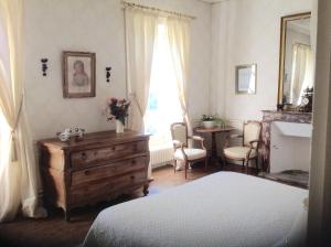 a bedroom with a bed and a dresser and a window at Chateau d'Yseron in Vallet