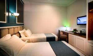 Postel nebo postele na pokoji v ubytování H Boutique Hotel Sri Petaling