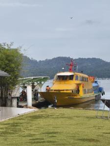 a yellow boat is docked at a dock at L23 ,88 Resort Villa House in Pangkor