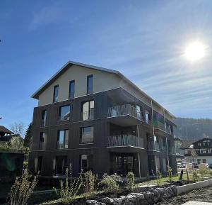 a large black building with the sun behind it at Widderkopf in Oberstaufen