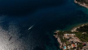 an aerial view of a boat in the water at Apartments Raymond in Sveti Stefan