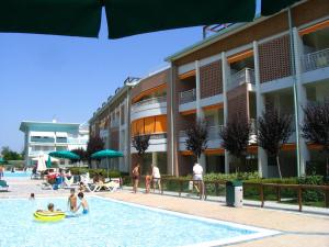 a group of people in a pool next to a building at Residenza Le Acacie in Bibione +37 photos