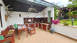 an outdoor patio with a table and a kitchen at Casa Vanatorului in Sighişoara