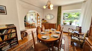 a dining room with a table and chairs at Casa Vanatorului in Sighişoara