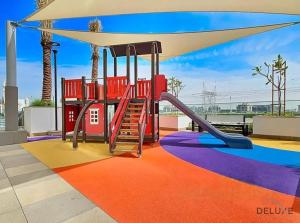 a playground with a slide on a roof at Charming Studio at Azizi Riviera 32, Al Merkadh by Deluxe Holiday Homes in Dubai