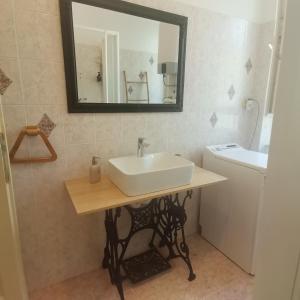 a bathroom with a sink and a mirror on the wall at APARTMAN FLAVIA in Rijeka +51 photos