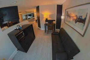 a living room with a flat screen tv on a wall at Coratel Inn & Suites by Jasper Hastings in Hastings +28 photos