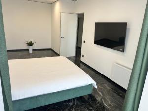 מיטה או מיטות בחדר ב-Люкс апартаменти в ЖКАрена